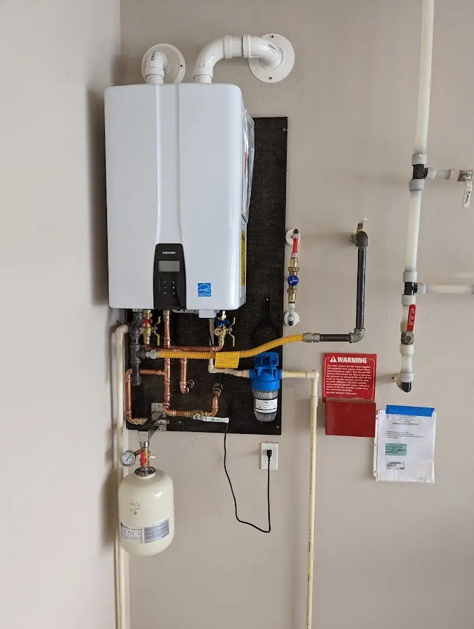 Professional plumber installing copper piping in a Slaton home